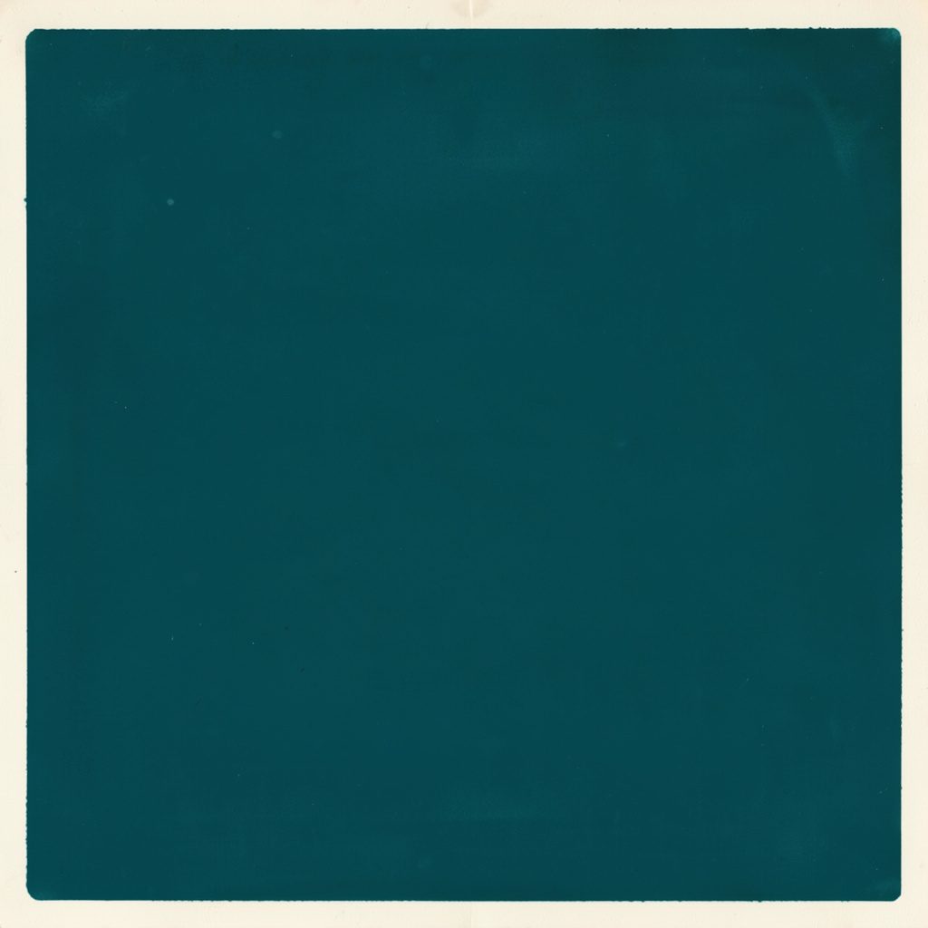 Small square emblem with teal and navy geometric shapes suggesting a circuit board, calm and technical mood
